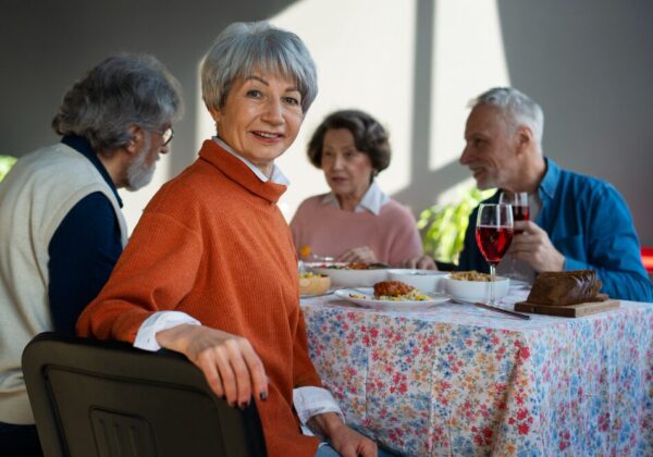 Group of smiling seniors sitting together during a community activity