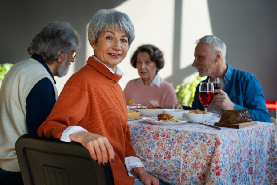 Group of smiling seniors sitting together during a community activity