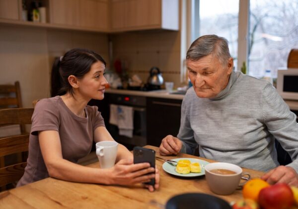 Caregiver assisting elderly woman with personal grooming in a calm, respectful setting