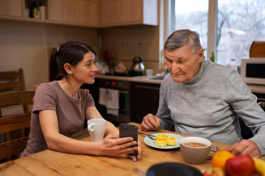 Caregiver assisting elderly woman with personal grooming in a calm, respectful setting